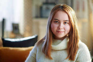 happy modern teenager girl at modern home in sunny winter day