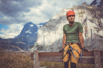 Young man climbing on a rock in Swiss Alps - via ferrata/klettersteig