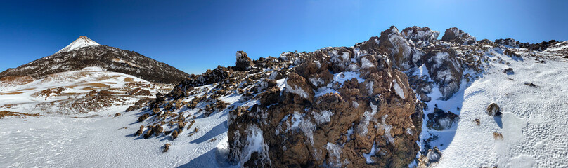 Peaks of Teide and Pico Viejo volcanoes at sunset seen from the Samara crater. Teide National Park,...