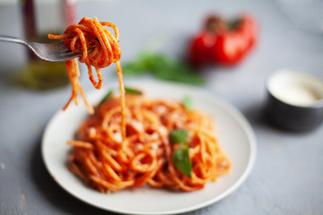 Tasty appetizing classic italian spaghetti pasta with tomato sauce, cheese parmesan and basil on...