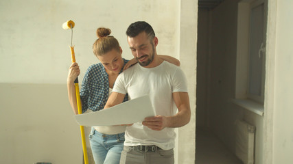 Man and woman look at scheme and talk