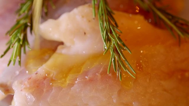 Closeup of preparing a fresh gilt-head bream fish meat with rosemary
