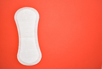 daily absorbent on a red background, hygiene of the woman