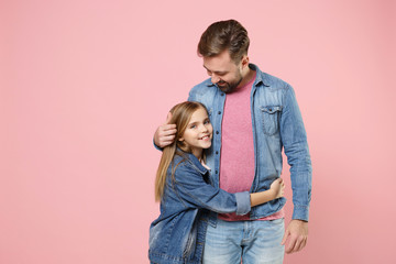 Pretty bearded man in casual clothes have fun with cute child baby girl. Father little kid daughter isolated on pastel pink background in studio. Love family parenthood childhood concept. Hugging.