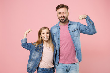 Smiling bearded man in casual clothes have fun with child baby girl. Father little kid daughter isolated on pastel pink background. Love family parenthood childhood concept. Showing biceps, muscles.