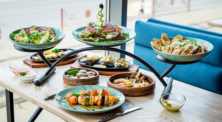 Different dishes on the table in a cafe, restaurant interior