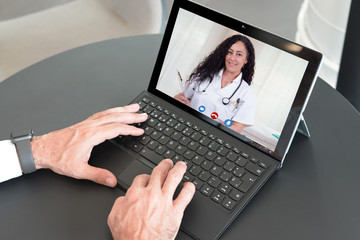 Laptop video call to talk to female doctor