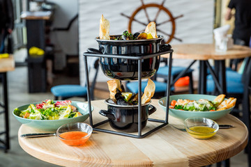 Different dishes on the table in a cafe, restaurant interior
