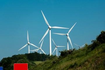 Wind power stations on a background of blue sky.