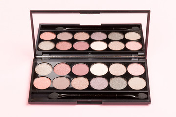 set of pastel eyeshadows isolated on rose background