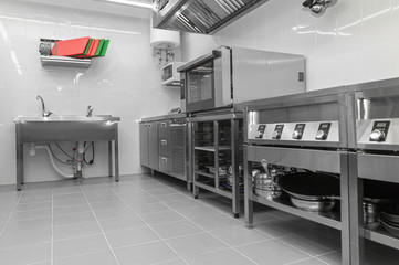 Design of the working area of the commercial cafe kitchen with stainless steel equipments, hot...