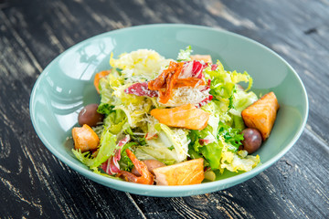 Green and healthy food salmon salad. Against a dark background