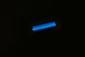 stylish blue AA battery on a black background