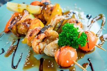 Shrimp and vegetable skewer on grill closeup