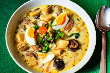 Creamy soup with boiled eggs, potato, carrot and different mushrooms