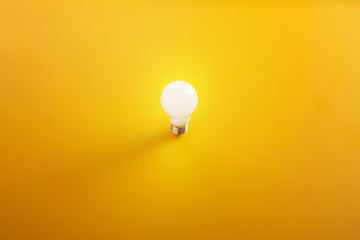 light bulb in a yellow background, minimalism design. 