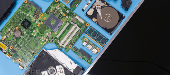 Parts of a modern computer. The insides of a laptop on a blue background, flat lay composition