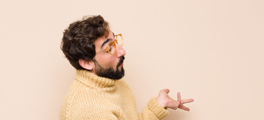 young cool man looking puzzled, confused and stressed, wondering between different options, feeling...