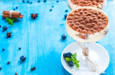 luxury tiramisu dessert in a cocktail glass decorated with cocoa