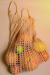 Obraz premium Fresh lemon, oranges, grapefruit and lime in string bag.