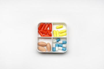 pile of medicine capsules in a box, pharmaceutical product, medicine in a health container.