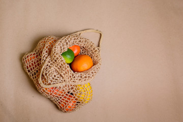 Fresh lemon, oranges, grapefruit and lime in string bag.