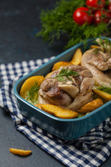 Boiled knuckle, served with cabbage and baked potatoes. Front view. Darkblue background. Dark mod.