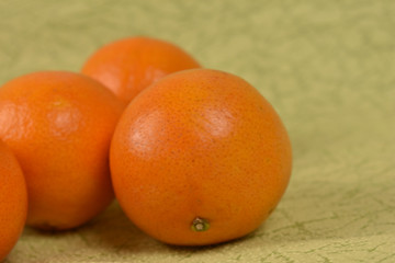 fresh tangerines on green table