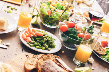 Vegetables and healthy food with glasses of drinks on table