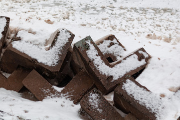 Bank protection - concrete breakwaters on the shore of Lake Ladoga on a cloudy winter day
