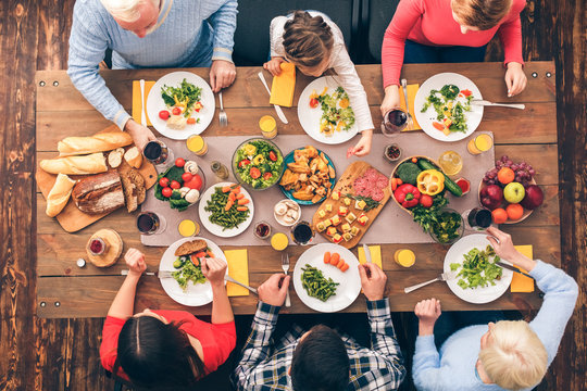 Big Family, Parents And Young Couple Sit And Eating