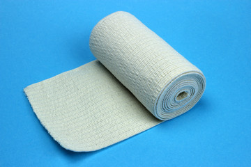 Medical bandage roll on a blue background