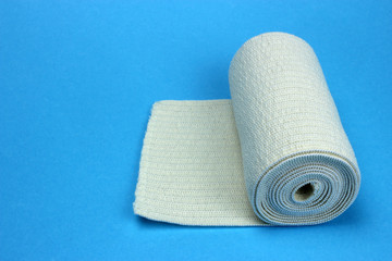 Medical bandage roll on a blue background