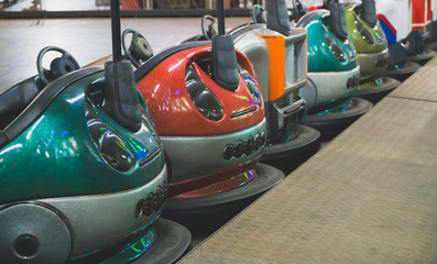 Bumper cars in the city amusement park at evening.