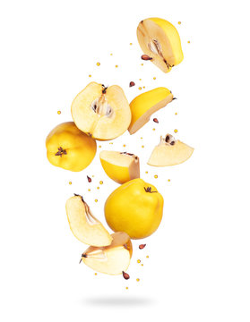 Whole and sliced ​​fresh quince in the air on a white background