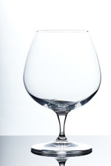 set of glass empty glasses and goblets on a gray-white background