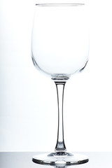 set of glass empty glasses and goblets on a gray-white background