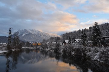 The village of Bad Goisern, Hallstatt in winter. View from the river to the town and the mountains, all covered with snow.