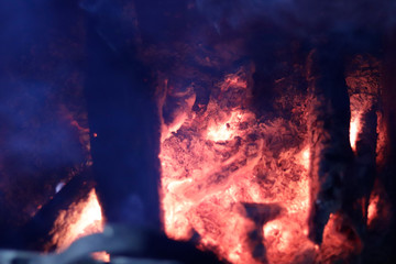 Burning coal, wood in a furnace with a bright red glow