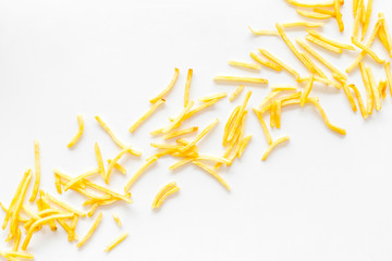 French fries background on white table top-down copy space