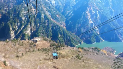 A blue cable car going down the mountain in Japan