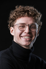 Obraz premium Close up of a handsome young curly haired businessman