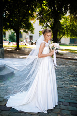 bride full length holding a bouquet of flowers