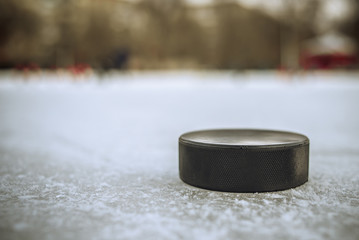 hockey puck lies on the snow close-up
