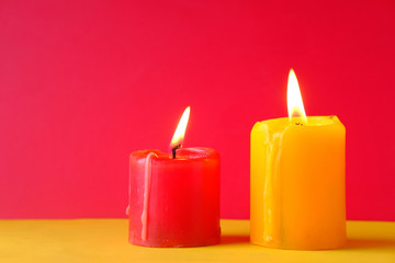 Obraz na płótnie Canvas Two Burning candle on color background, close up 