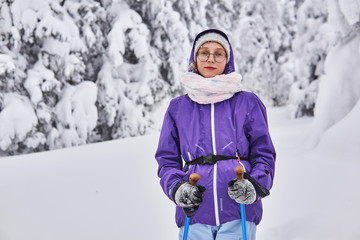amateur skier girl in winter snowy forest