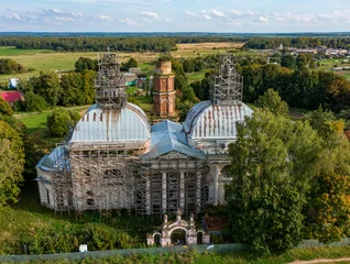 Deurstickers Old destroyed Orthodox church among green trees and fields, reconstruction and repair of an old historic building. Aerial photography © Антон Мазаев