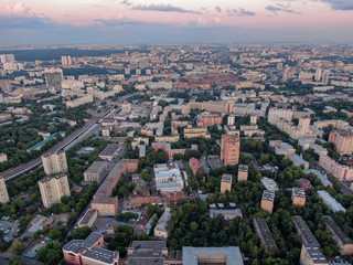 Top view of the evening city, in the frame of the house and road, streets and bridges. Aerial photography