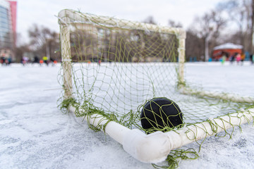 hockey puck in the goal net close-up