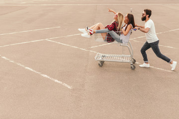 Young hipsters having fun on parking lot